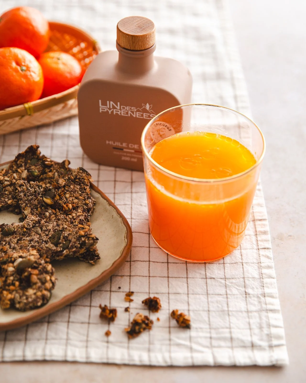 Flaxseed crackers and a carrot juice, on a table