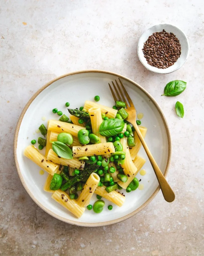 Des pâtes aux petits pois et aux graines de lin, dans une assiette